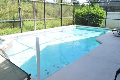 a large swimming pool with blue water at 2551 Oneida Grantham! in Kissimmee