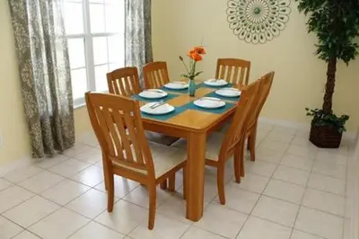 a dining room table with four chairs and a table and a table at 8056 Indian Creek Blvd in Kissimmee
