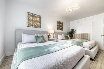 a bedroom with two beds and a couch at Apartment - near Epic Universe and Universal, free parking in Orlando