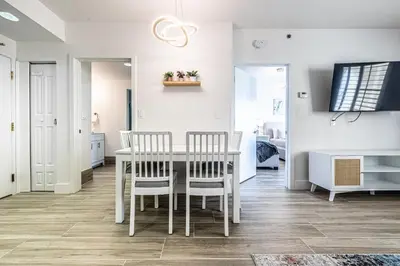 a kitchen and dining room with a table and chairs at One bedroom unit near Epic Universe and Universal, free parking in Orlando