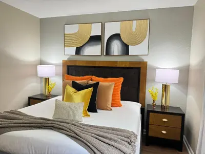 a bedroom with a bed with orange and yellow pillows at P42 New Townhouse at Vista Cay Walking distance to CCCO in Orlando