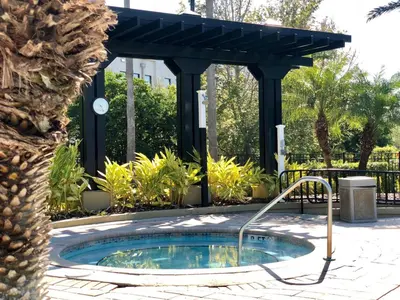 a hot tub in a garden with a pergola at P42 New Townhouse at Vista Cay Walking distance to CCCO in Orlando