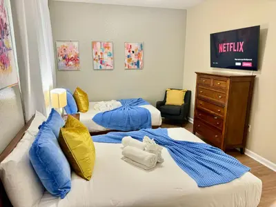 a bedroom with two beds and a dresser at P42 New Townhouse at Vista Cay Walking distance to CCCO in Orlando