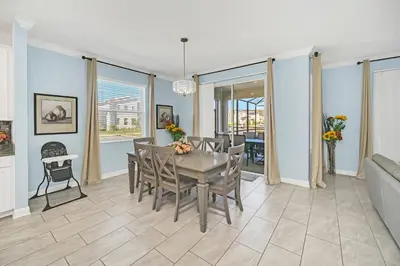 a dining room with a table and chairs at Spotless 6 bedroom Villa - Storey Lake - Hot tub - Free Water Park - 15 Mins to Disney in Kissimmee