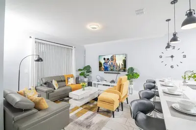 a living room with a table and a dining room at EPIC STYLISh retreat With Free water park near Disney in Kissimmee