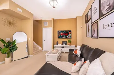 a living room with a couch and a table at Epic Arty Retreat near Disney in Kissimmee