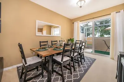 a dining room with a table and chairs at Epic Arty Retreat near Disney in Kissimmee