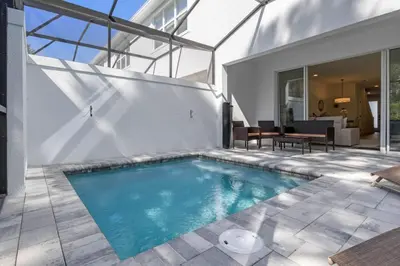 a swimming pool in the middle of a house at Modern Townhouse Heated Pool Disney Orlando 17244 in Orlando
