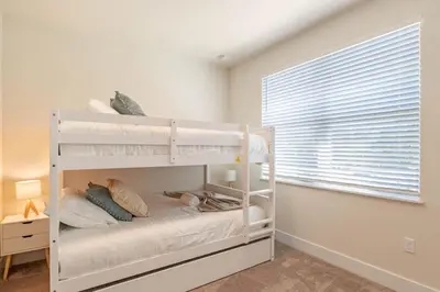 a white bunk bed in a room with a window at Modern Townhouse Heated Pool Disney Orlando 17244 in Orlando