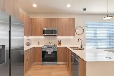 a kitchen with a stove and a microwave at Modern Townhouse Heated Pool Disney Orlando 17244 in Orlando