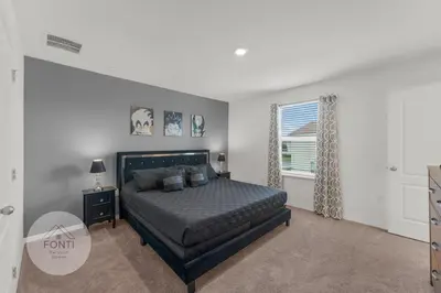 a bedroom with a bed and a window at 4875 Resort Townhouse by Disney World Orlando in Kissimmee