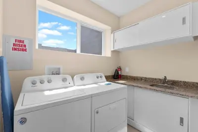 a white kitchen with a sink and a window at Luxury 4BR Townhouse Next to Disney Orlando 3201 in Orlando