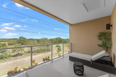 a balcony with a couch and a view of a field at Luxury 4BR Townhouse Next to Disney Orlando 3175 in Orlando