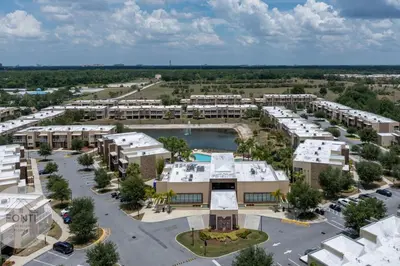 an aerial view of an apartment complex with a parking lot at Luxury 4BR Townhouse Next to Disney Orlando 3175 in Orlando