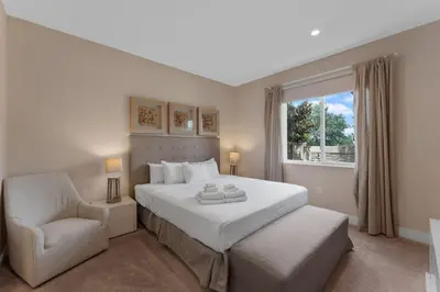 a bedroom with a bed and a chair and a window at Luxury 4BR Townhouse Next to Disney Orlando 3173 in Orlando