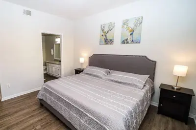 a bedroom with a bed with two night stands and two lamps at Runaway Beach Club Resort Condo Apt Disney 15103 in Kissimmee