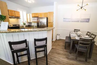a kitchen and dining room with a table and chairs at Runaway Beach Club Resort Condo Apt Disney 15103 in Kissimmee