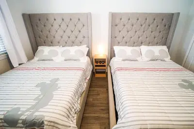 two beds sitting next to each other in a bedroom at Runaway Beach Club Resort Condo Apt Disney 15103 in Kissimmee
