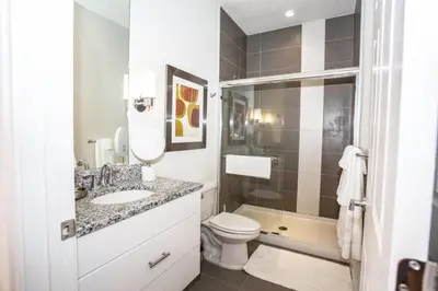 a bathroom with a sink and a toilet and a shower at Modern Townhouse Heated Pool Disney Orlando 1500R in Orlando