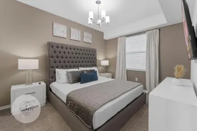 a bedroom with a large bed and a window at Modern Storey Lake Resort Disney Orlando 3191-307 in Kissimmee