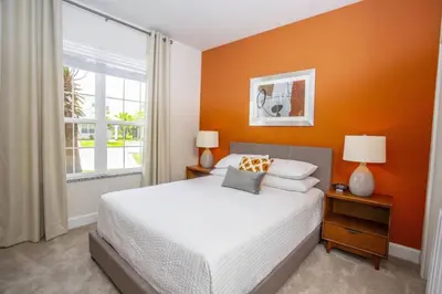 a bedroom with a bed and a large window at Modern Townhouse Heated Pool Disney Orlando 1502R in Orlando