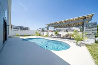 a swimming pool in the middle of a backyard at Vacation Oasis Home with Private Pool and Grill 8615 in Kissimmee