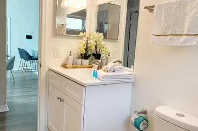 a white bathroom with a sink and a mirror at Vacation Oasis Home with Private Pool and Grill 8615 in Kissimmee