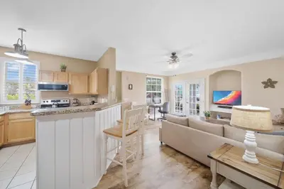 a kitchen and living room with a couch and a table at Runaway Beach Club Resort Condo Apt Disney 6102 in Kissimmee