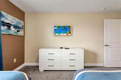 a bedroom with two beds and a white dresser at Storey Lake Resort Townhouse near Disney Orlando 4847 in Kissimmee