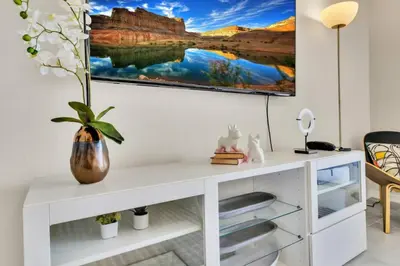 a white desk in a room with a painting on the wall at Modern Storey Lake Resort Disney Orlando 3150-303 in Kissimmee