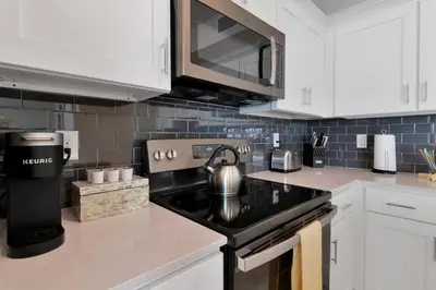 a kitchen with a stove with a tea kettle on it at Modern Storey Lake Resort Disney Orlando 3150-303 in Kissimmee