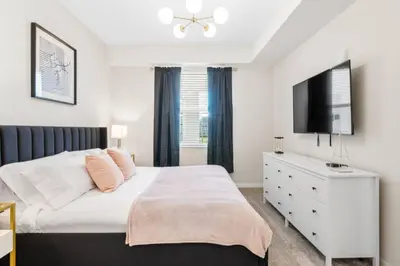 a bedroom with a white bed and a flat screen tv at Modern Storey Lake Resort Disney Orlando 3171-206 in Kissimmee