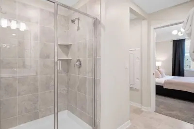 a bathroom with a shower with a glass door at Modern Storey Lake Resort Disney Orlando 3171-206 in Kissimmee