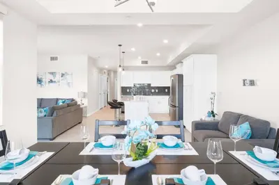 a kitchen and living room with a table and chairs at Modern Storey Lake Resort Disney Orlando 3161-107 in Kissimmee