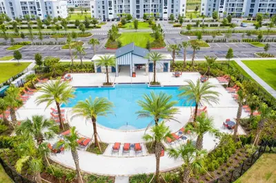 an aerial view of a resort pool with palm trees at Modern Storey Lake Resort Disney Orlando 3161-107 in Kissimmee
