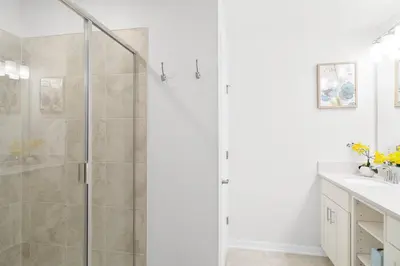 a shower with a glass door in a bathroom at Modern Storey Lake Resort Disney Orlando 3191-103 in Kissimmee