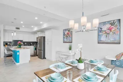 a kitchen and living room with a table and a dining room at Modern Storey Lake Resort Disney Orlando 3191-106 in Kissimmee