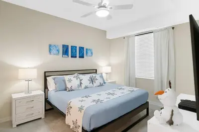 a white bedroom with a bed and a window at Modern Boho Storey Lake Resort Disney 3150-106 in Kissimmee