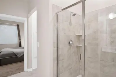 a shower with a glass door in a bathroom at Modern Storey Lake Resort Disney Orlando 3161-401 in Kissimmee