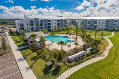 an aerial view of a resort with a pool and palm trees at Modern Storey Lake Resort Disney Orlando 3121-402 in Kissimmee