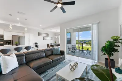 a living room with a couch and a ceiling fan at Modern Storey Lake Resort Disney Orlando 3161-405 in Kissimmee