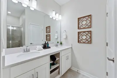 a white bathroom with a sink and a mirror at Modern Storey Lake Resort Disney Orlando 3161-405 in Kissimmee