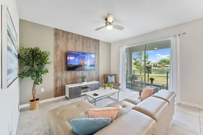 a living room with a couch and a tv at Modern Storey Lake Resort Disney Orlando 3141-103 in Kissimmee