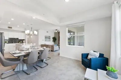 a dining room and kitchen with a dining table and chairs at Modern Storey Lake Resort Disney Orlando 3141-103 in Kissimmee