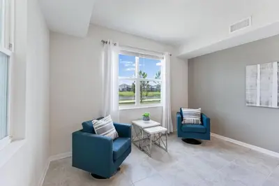 a living room with two chairs and a window at Modern Storey Lake Resort Disney Orlando 3141-103 in Kissimmee
