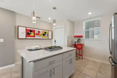 a kitchen with a sink and a refrigerator at Modern Storey Lake Resort Disney Orlando 3171-304 in Kissimmee