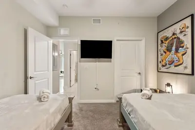 a bedroom with two beds and a flat screen tv at Modern Storey Lake Resort Disney Orlando 3171-304 in Kissimmee