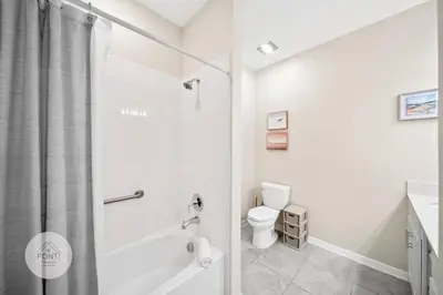 a white bathroom with a toilet and a shower at Modern Storey Lake Resort Disney Orlando 3161-402 in Kissimmee