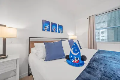 a bedroom with a bed with a teddy bear on it at Modern Boho Storey Lake Resort Disney 3180-207 in Kissimmee