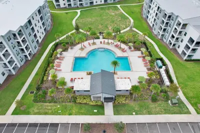 an aerial view of a building with a swimming pool at Modern Storey Lake Resort Disney Orlando 3121-108 in Kissimmee